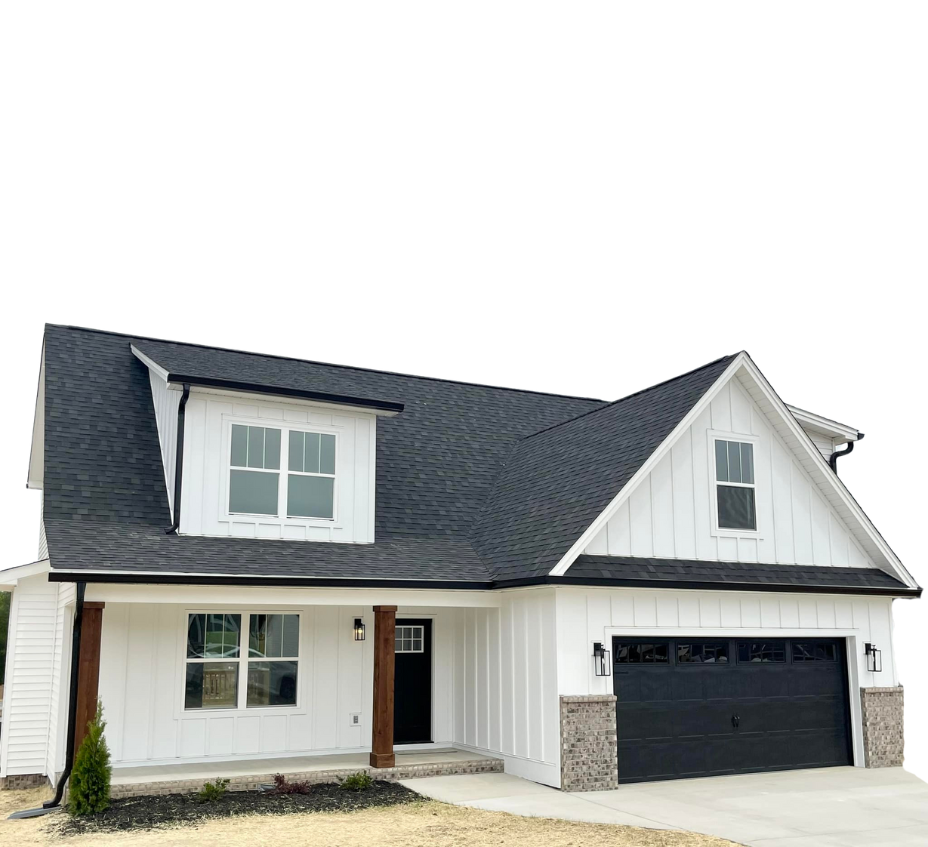 A white house with a black roof and a black garage door.