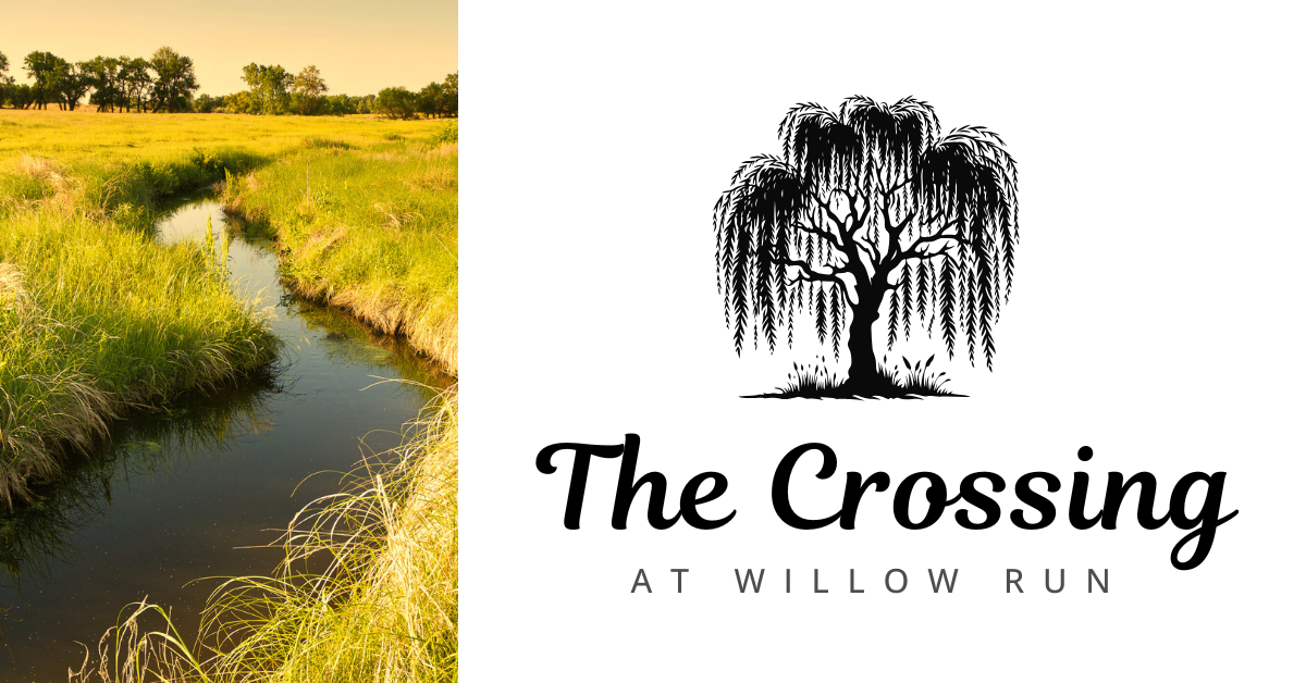 A woman in a green shirt is laughing with her mouth open