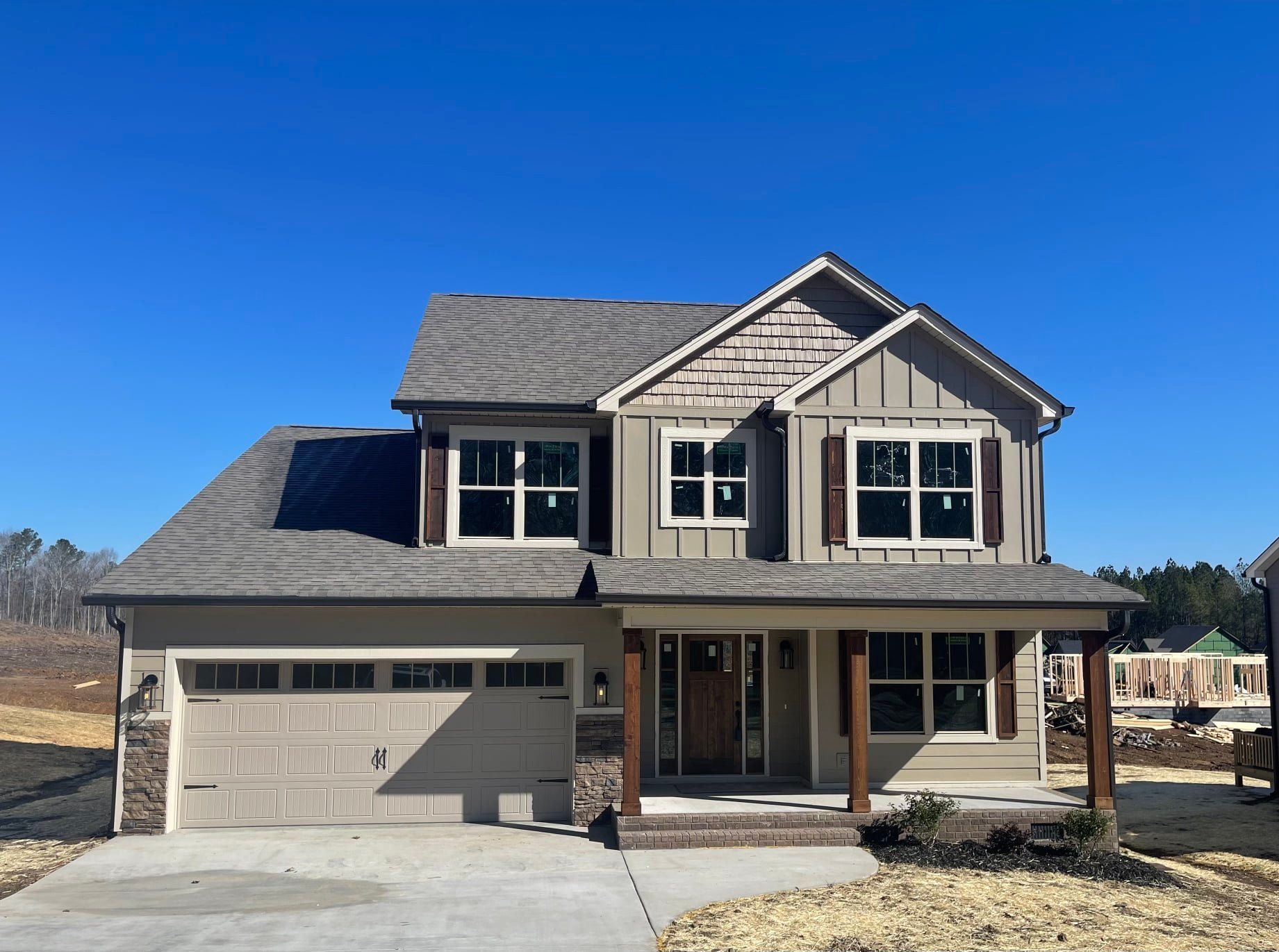 A house with a lot of windows and a large garage