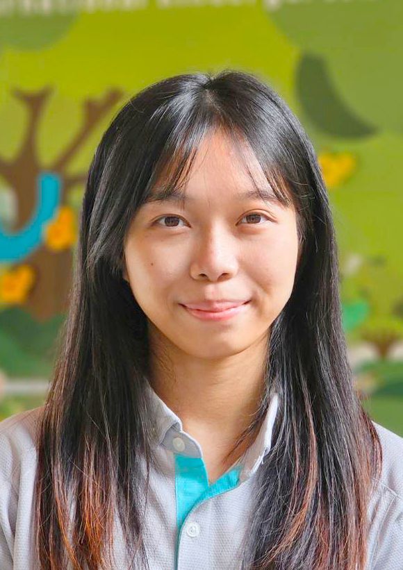 Co-Teacher, A young woman with long hair is smiling for the camera.