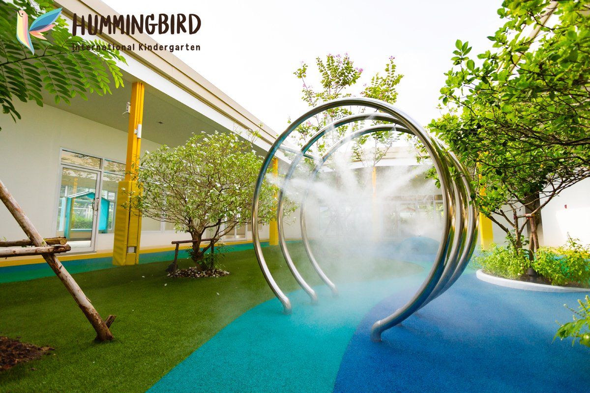 A hummingbird logo is on the side of a building