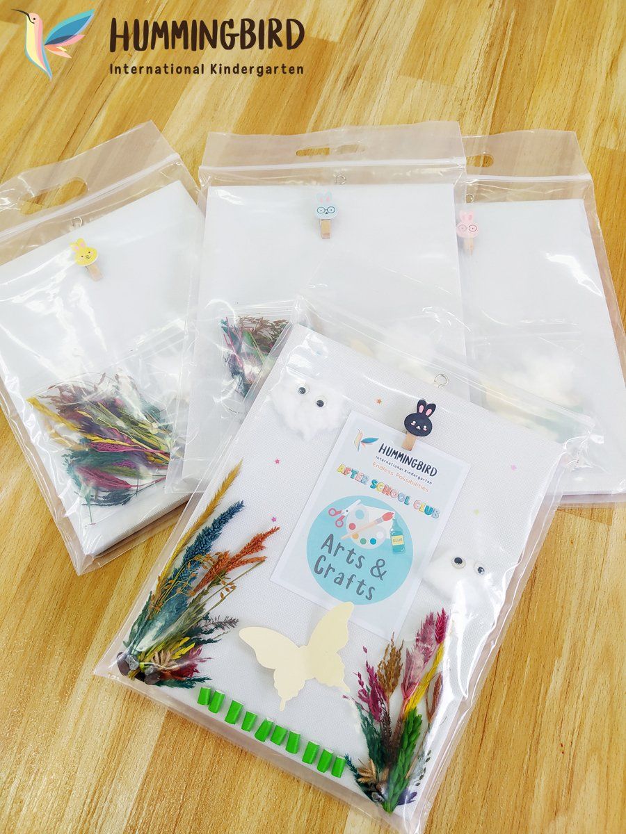Three bags of dried flowers are sitting on a wooden table.