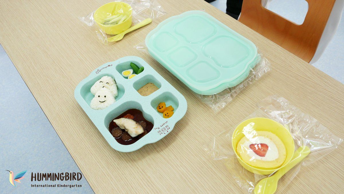 A table with plates , bowls and spoons on it.