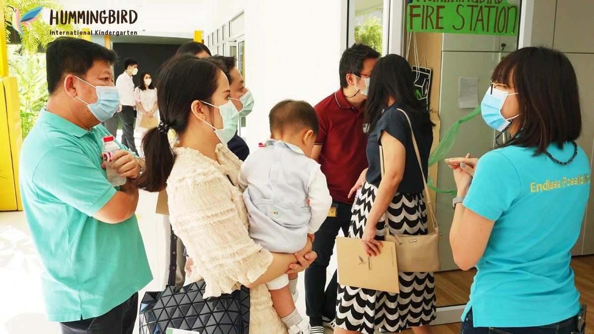 A group of people wearing face masks are standing in a line.