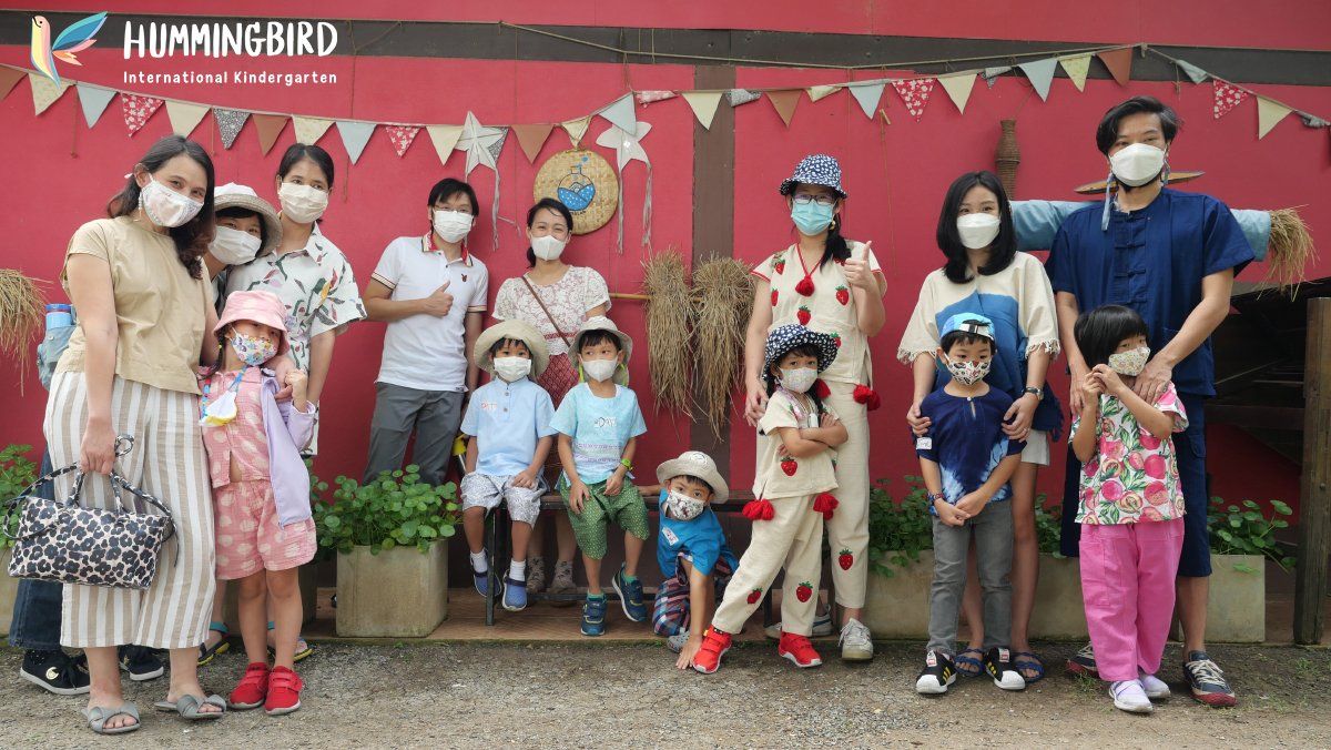 A group of people wearing face masks are posing for a picture.