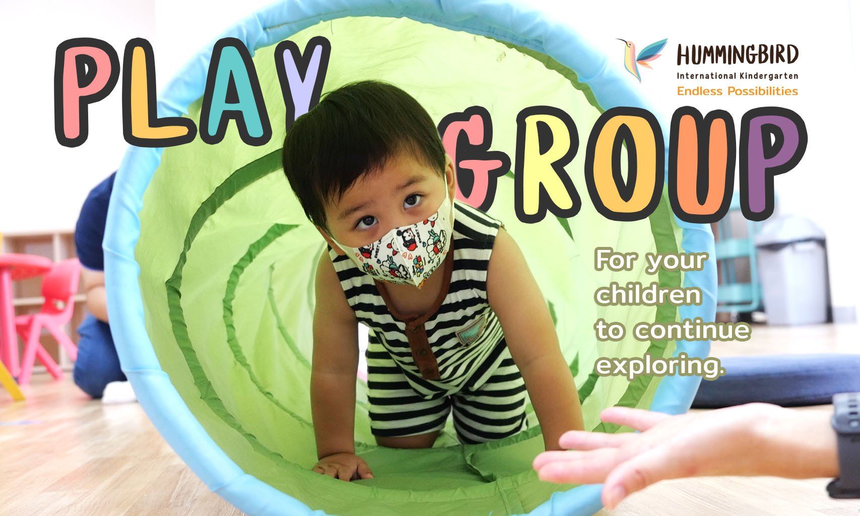 A baby wearing a mask is crawling through a tunnel.