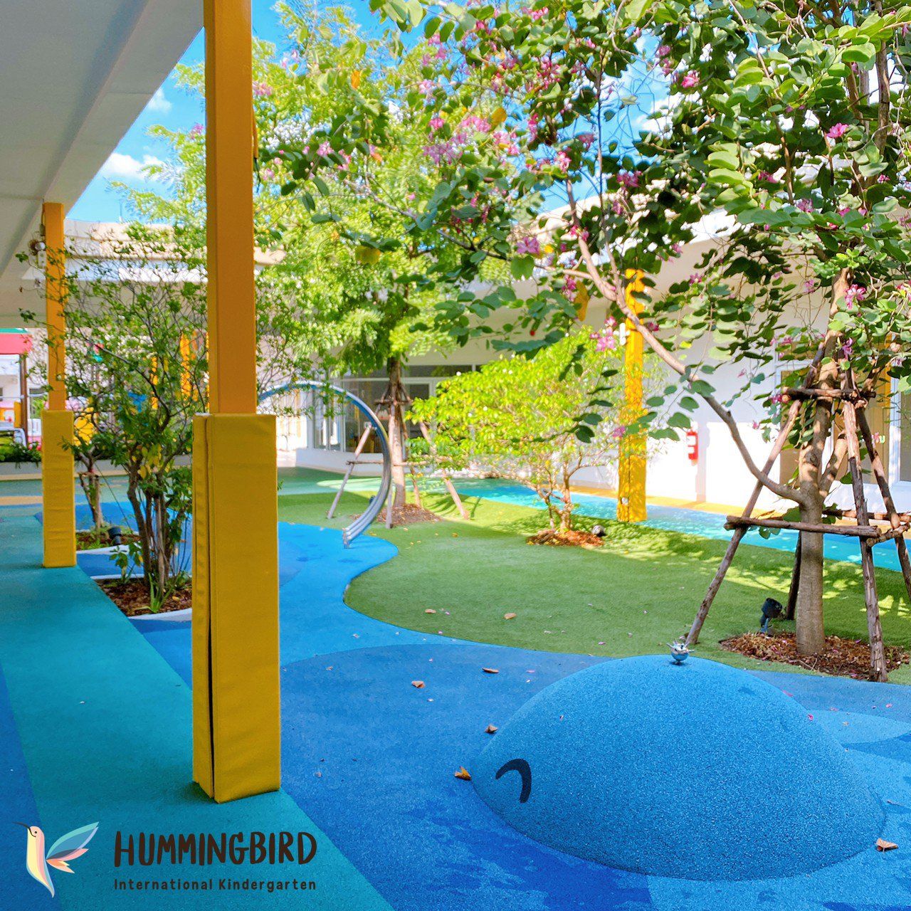 A hummingbird logo is on the side of a building