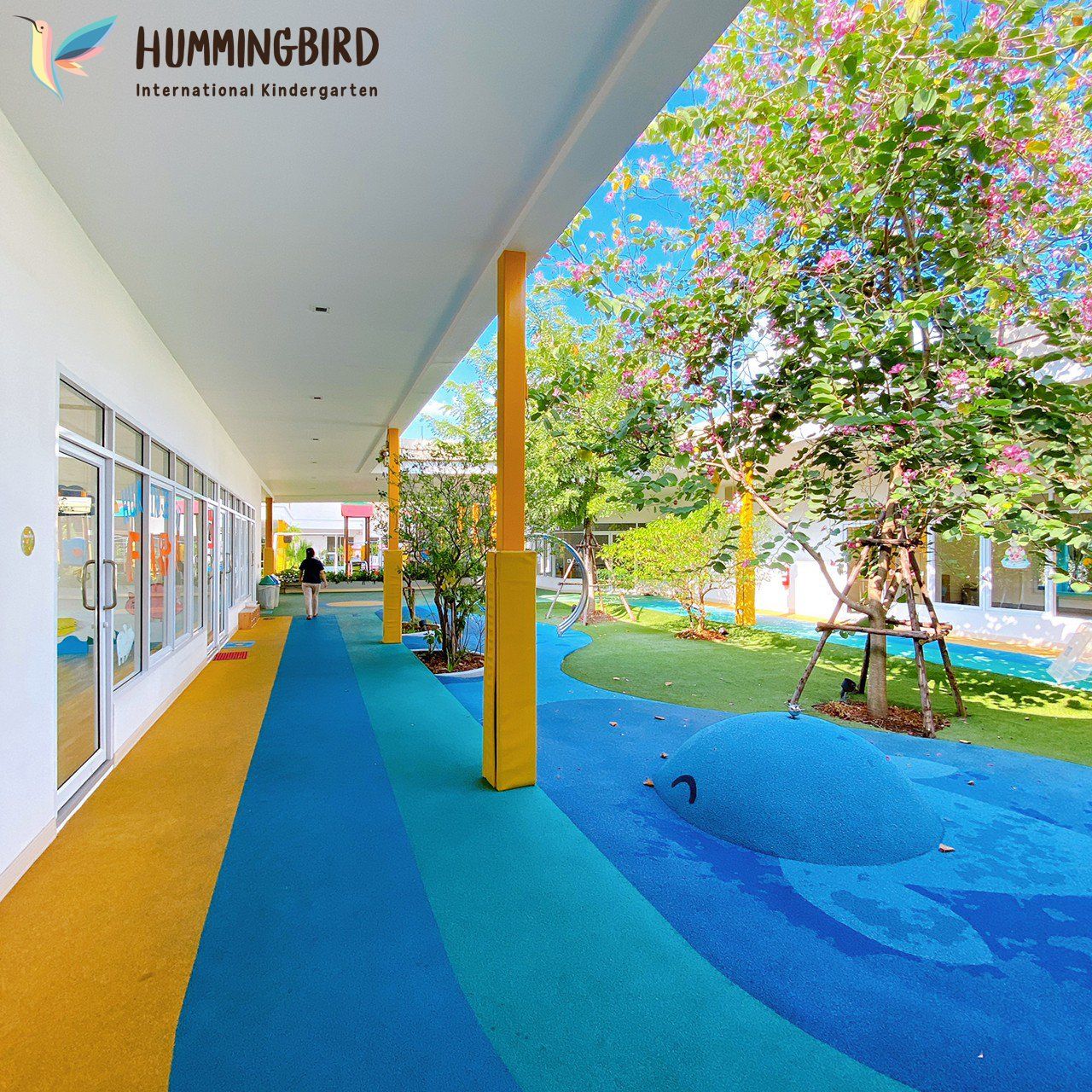 A hummingbird international kindergarten is shown on the side of a building