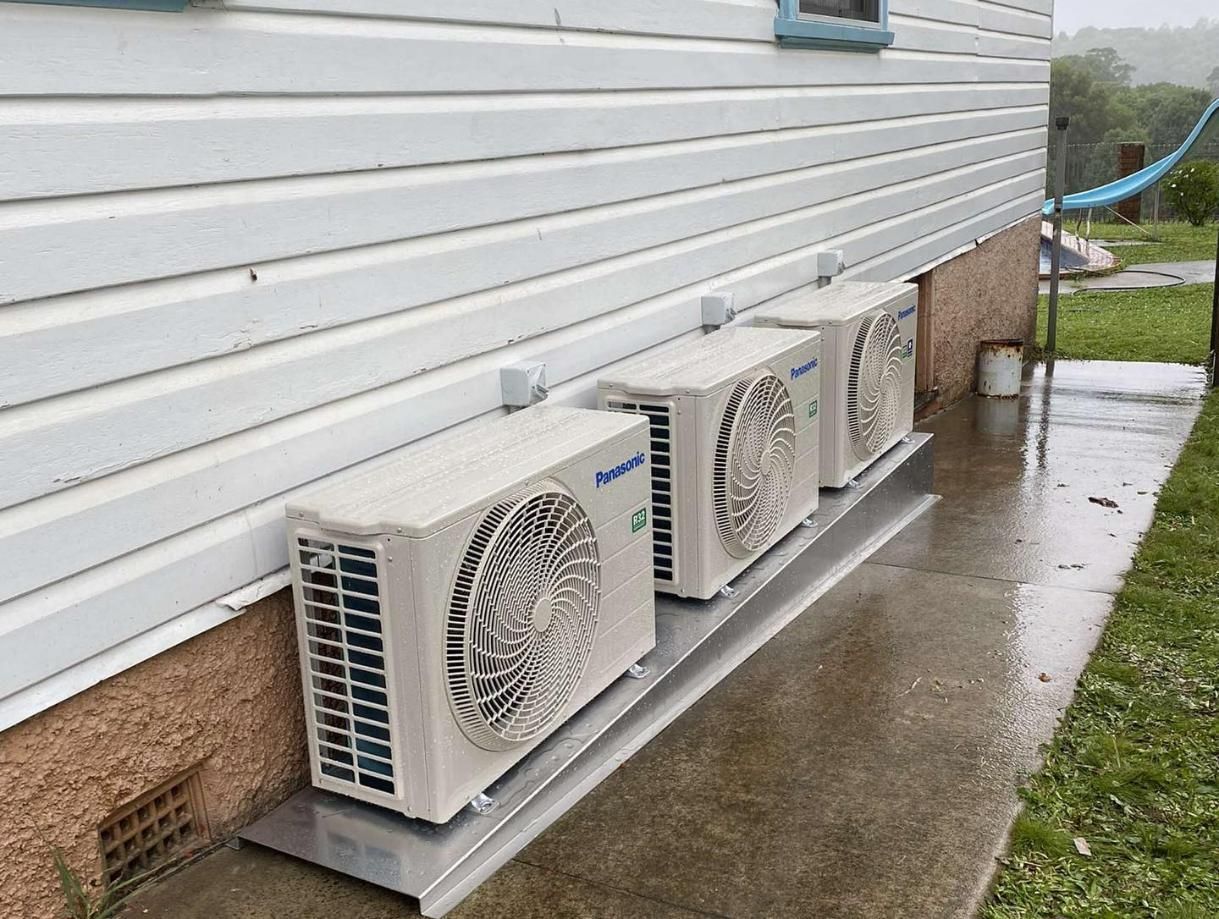Row of Air Conditioning Units Outside of a House