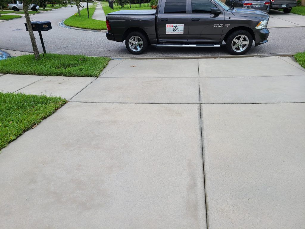 Clean driveway with the business car — Apollo Beach, FL — EGA Parking Lot Striping & Pressure Washing