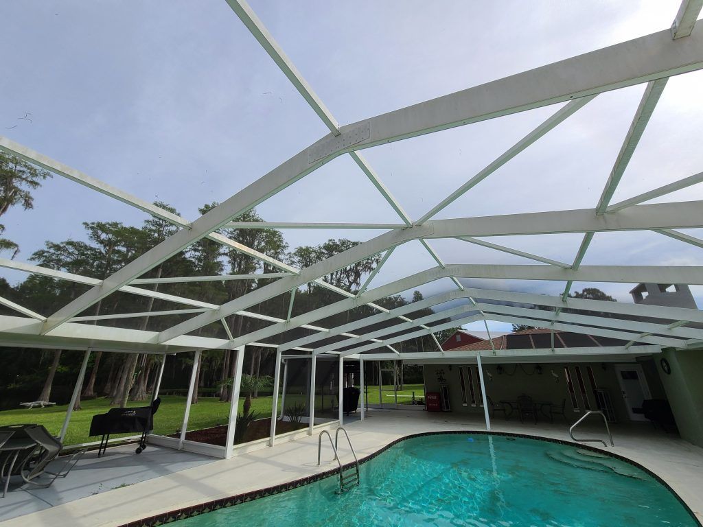 Pressure washing at a pool enclosure — Apollo Beach, FL — EGA Parking Lot Striping & Pressure Washing