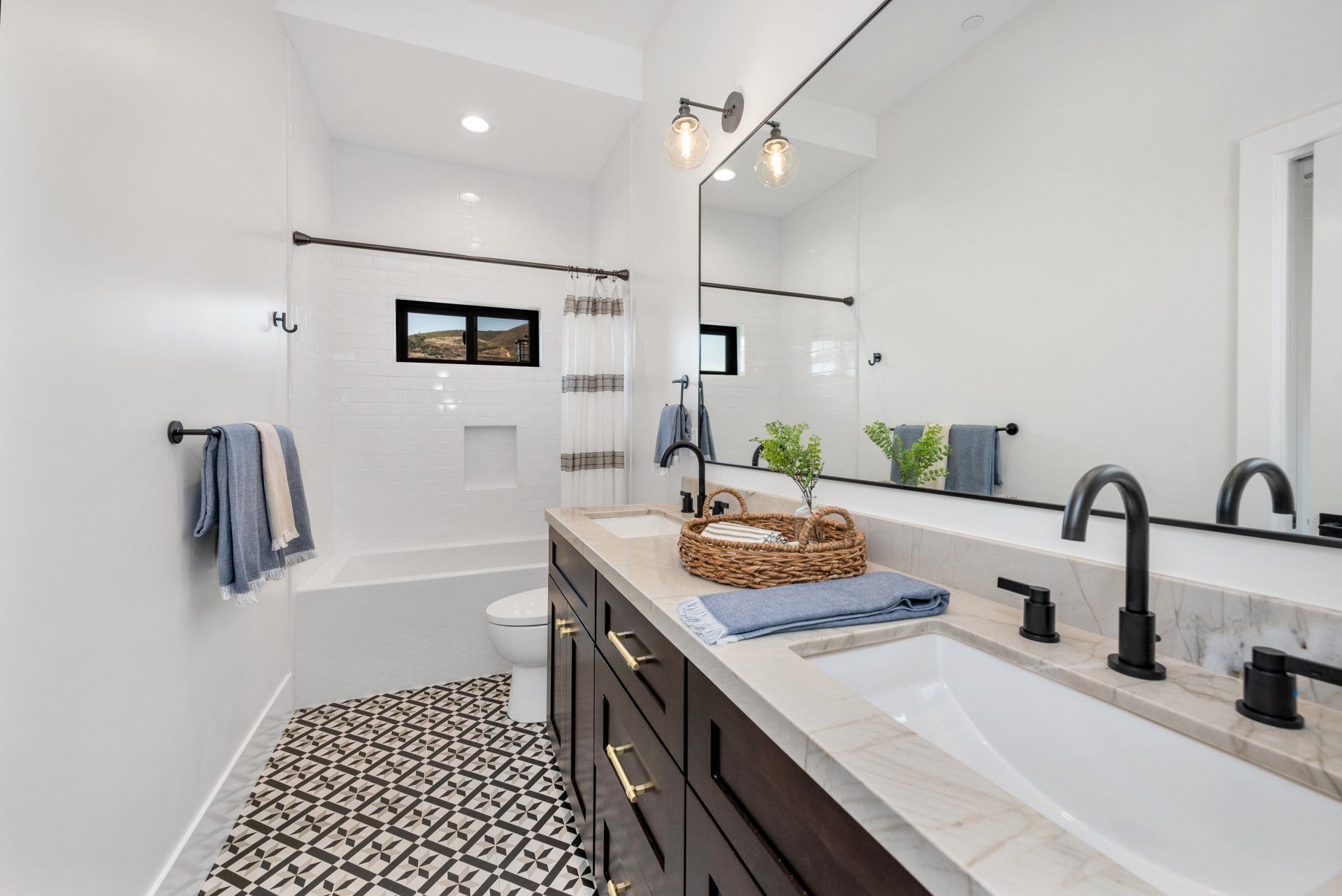 A bathroom with a sink, mirror and bathtub.