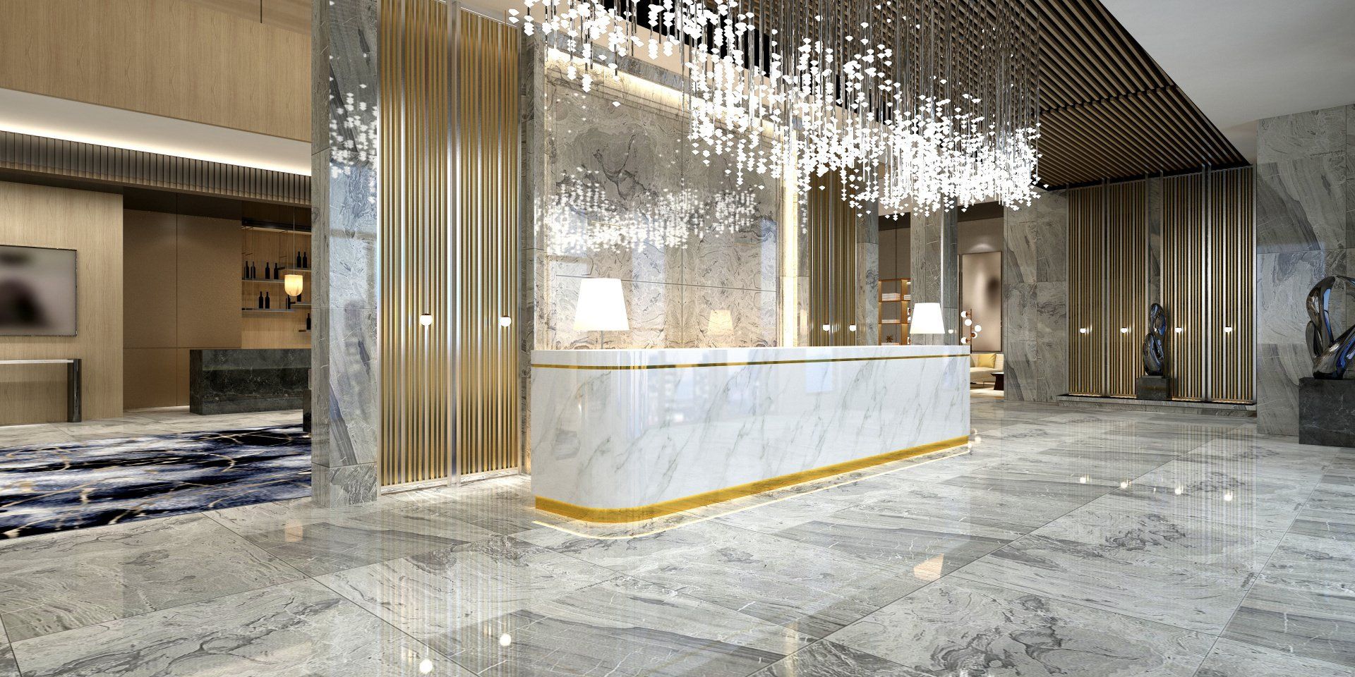 A lobby with a marble counter and a chandelier hanging from the ceiling.
