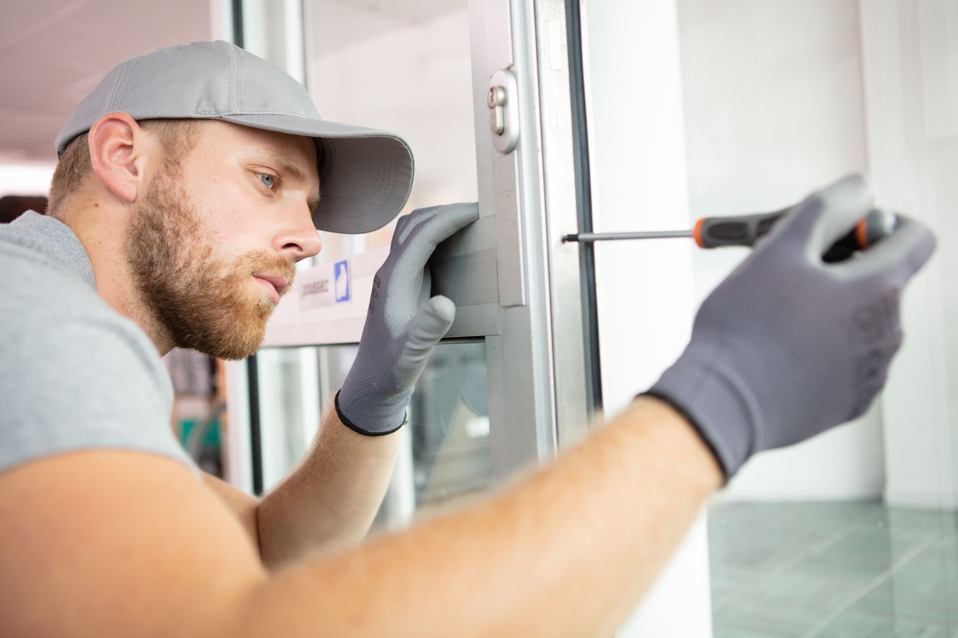 A locksmith installing a door lock.