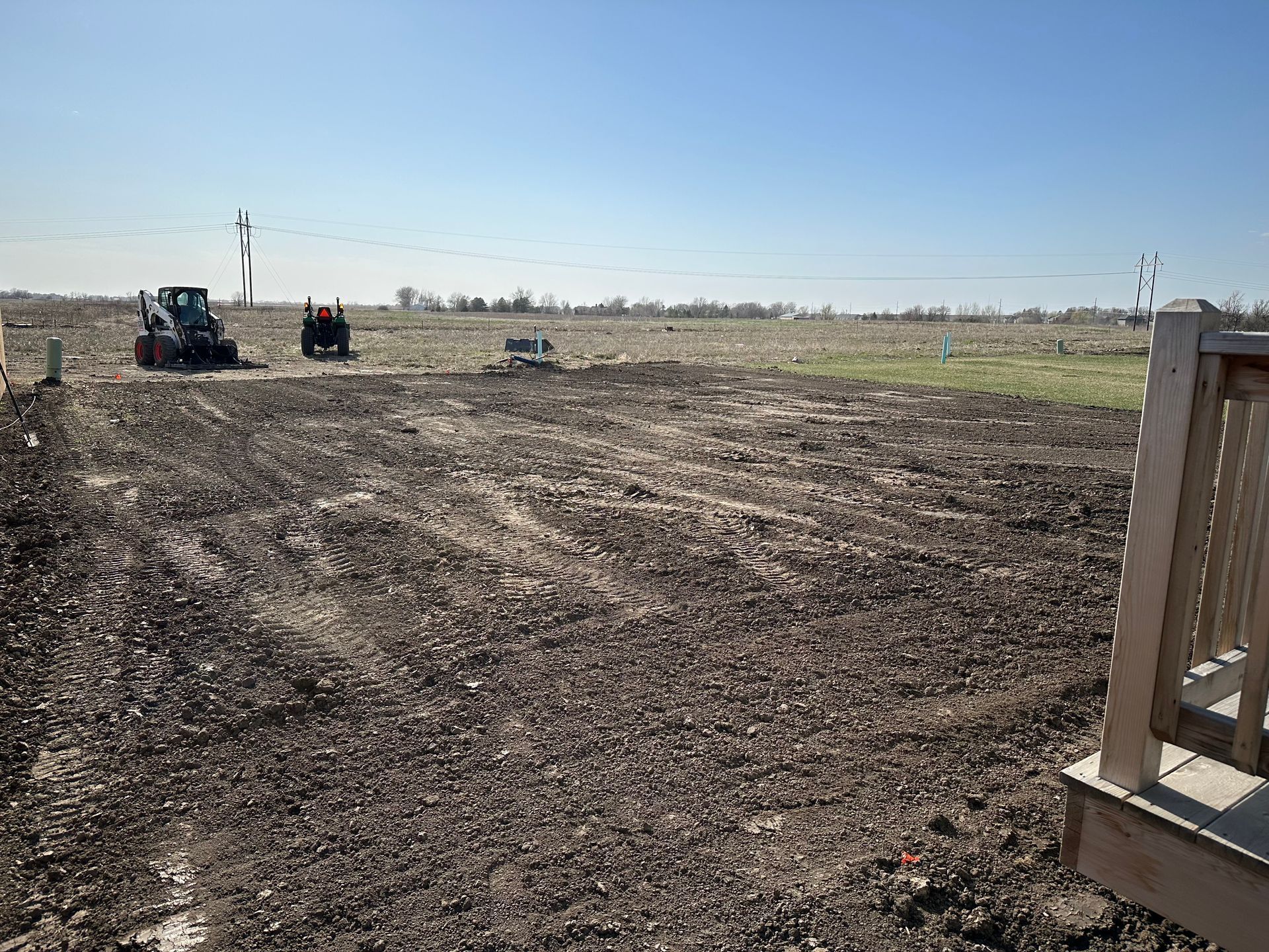 A house is being built in the middle of a dirt field.