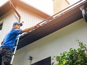 Expert Gutter Cleaners — Man Cleaning A Gutter In Mount Holly, NC