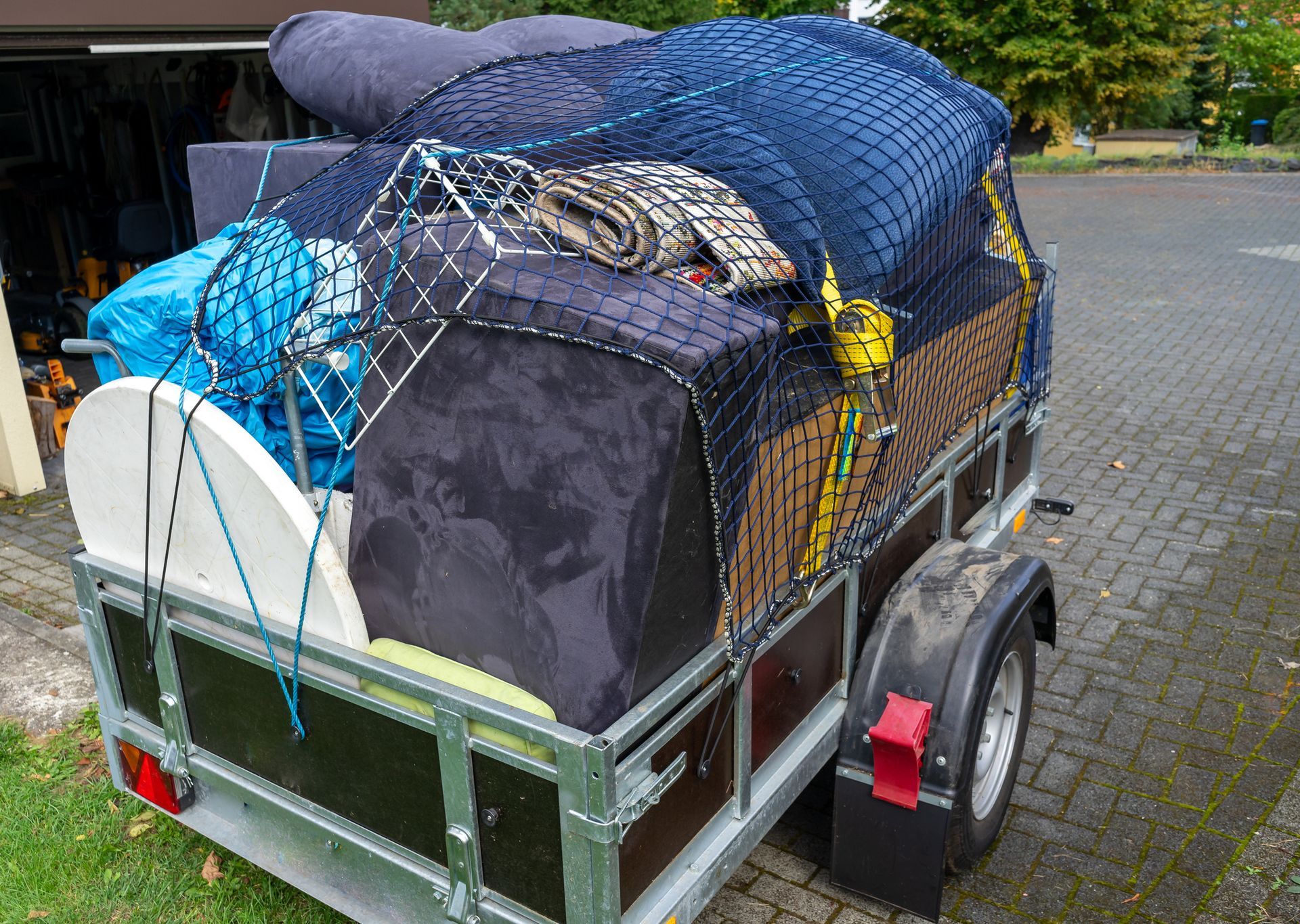 A trailer is loaded with a lot of items including a couch