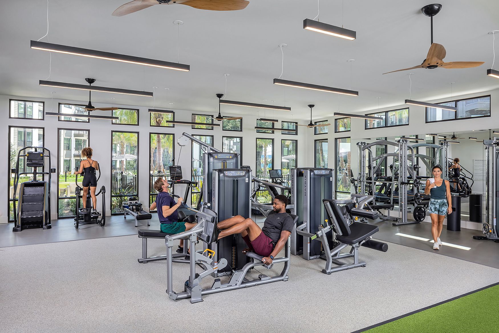 A man and a woman are sitting at a table in a large room.