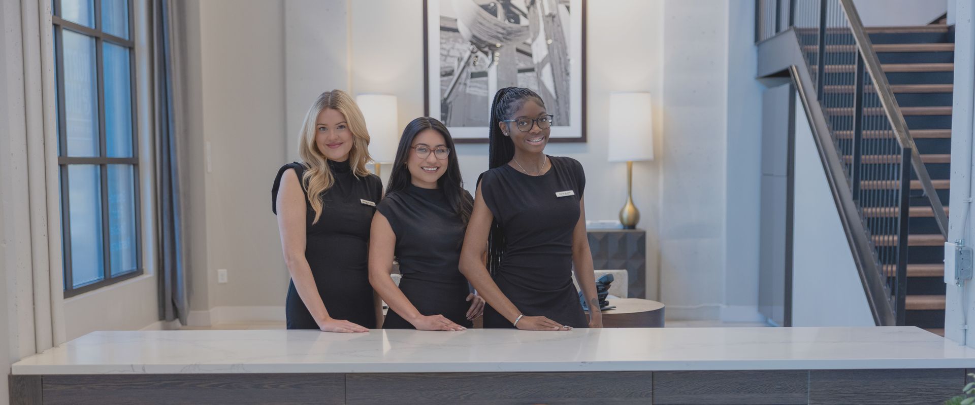 A group of people are sitting on a couch having a meeting.