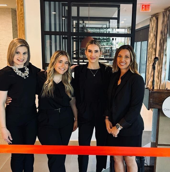 A group of women standing in front of an exit sign