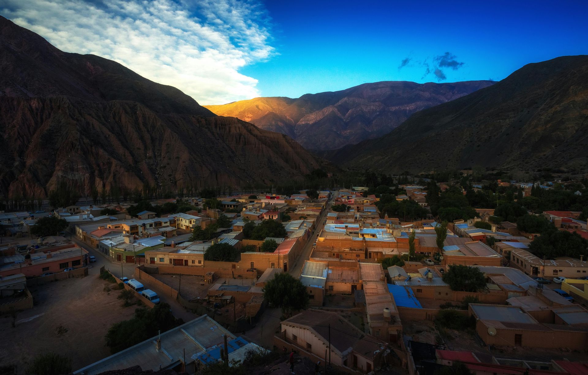 Emerald Bay at Lake Tahoe featuring a small island, deep blue water, surrounded by dense pine forests under a clear sky.