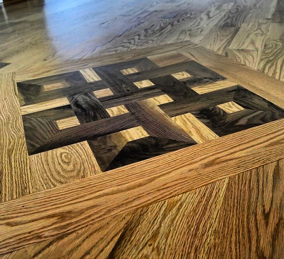 A close up of a wooden floor with a pattern on it.