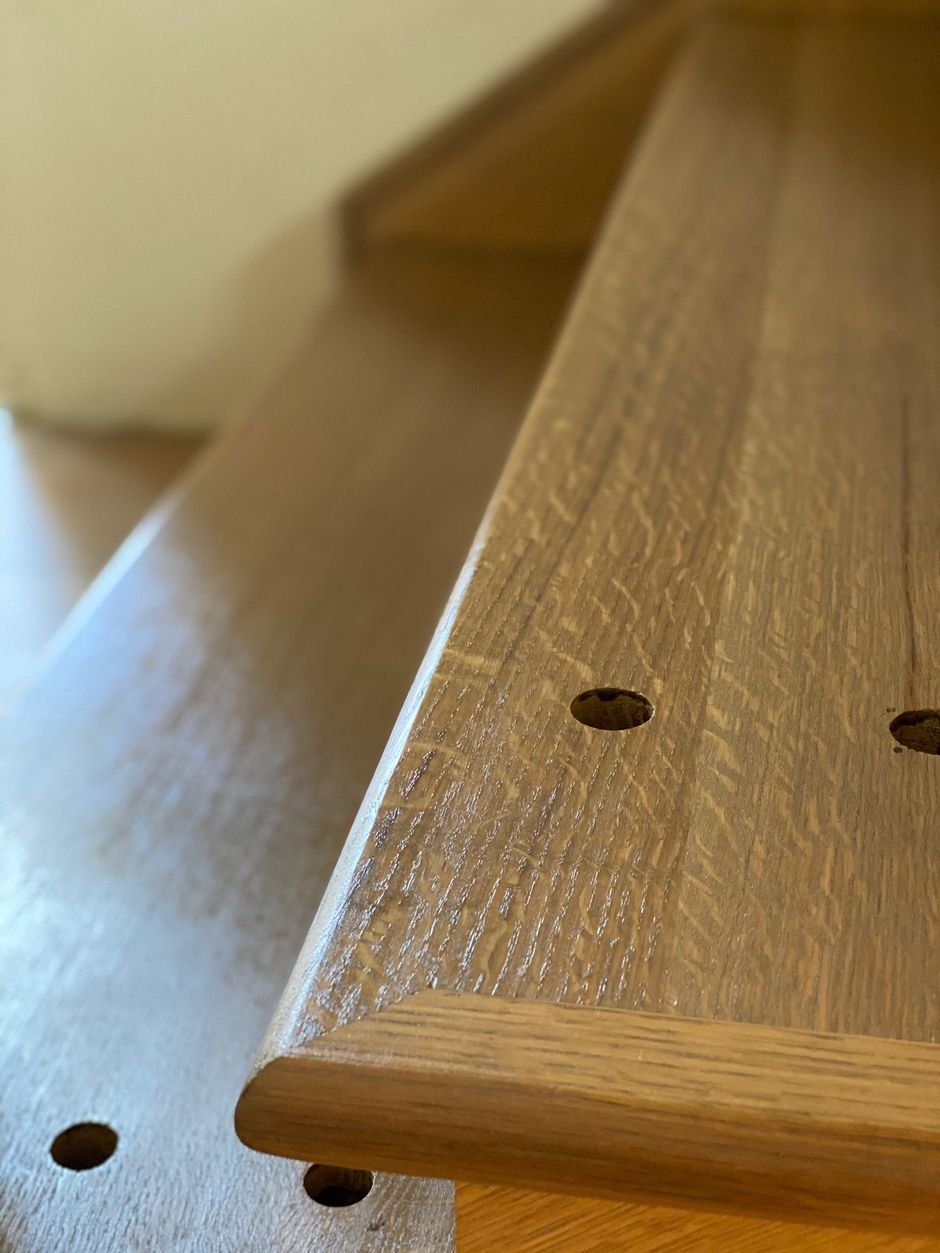 A close up of a wooden table with holes in it