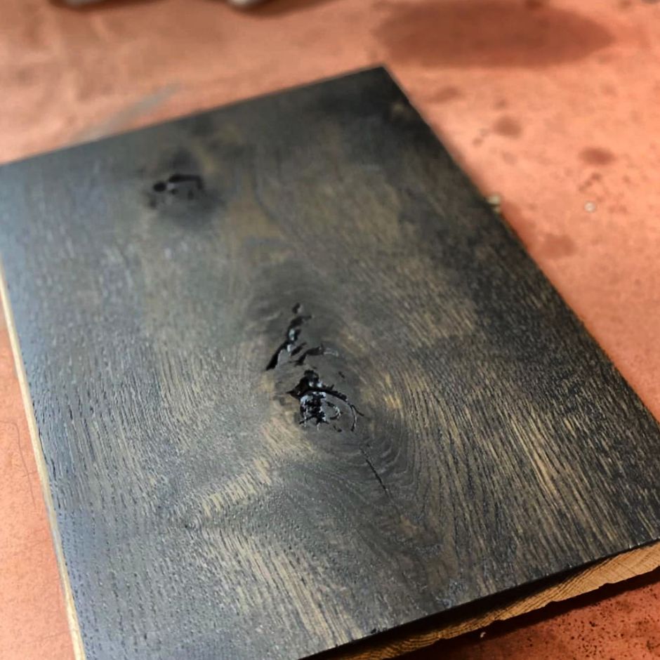 A piece of black wood is sitting on a table