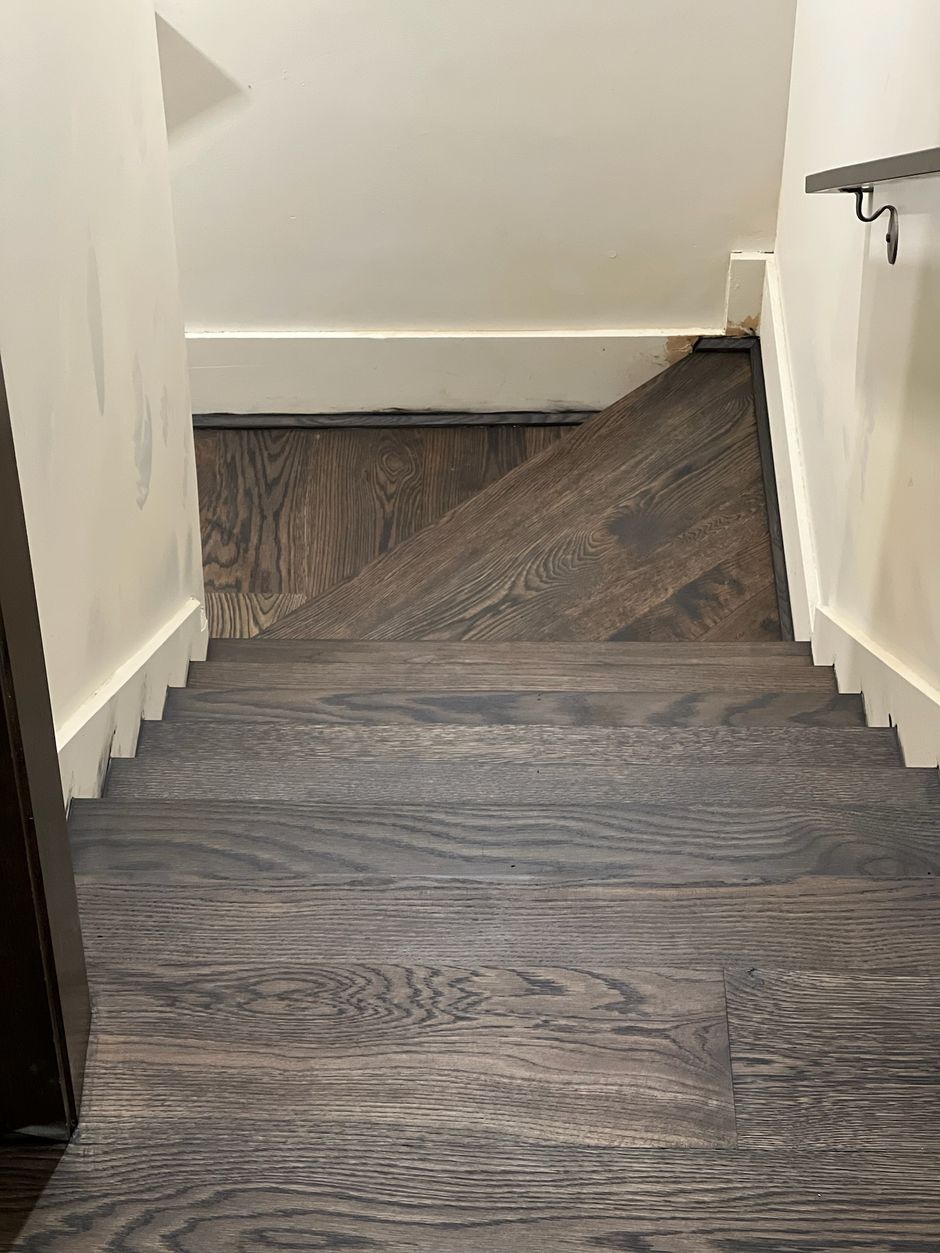 A set of wooden stairs leading up to the second floor of a house.