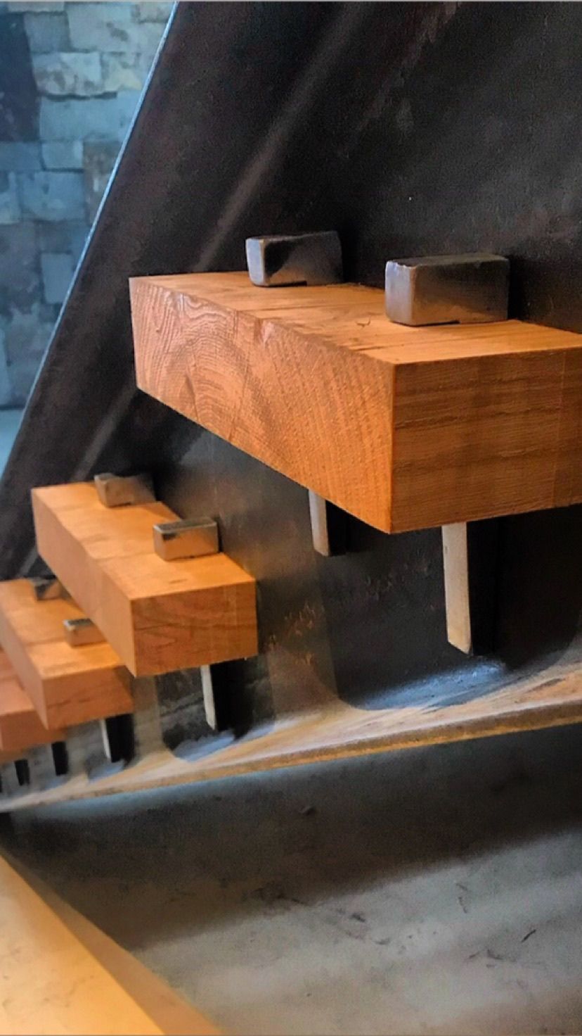 A close up of a wooden staircase with a metal railing