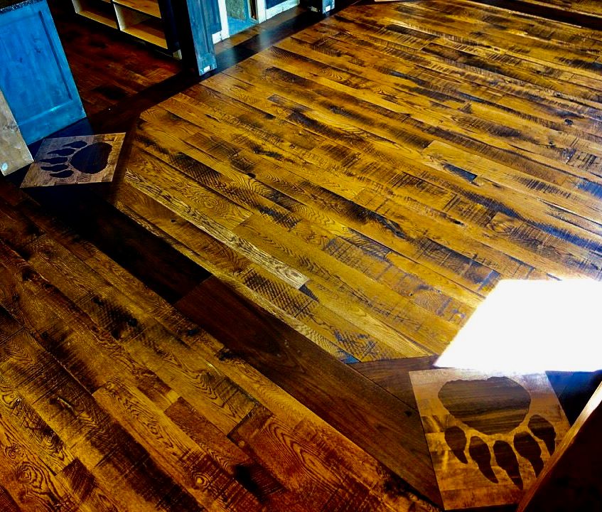 A wooden floor with a bear paw print on it