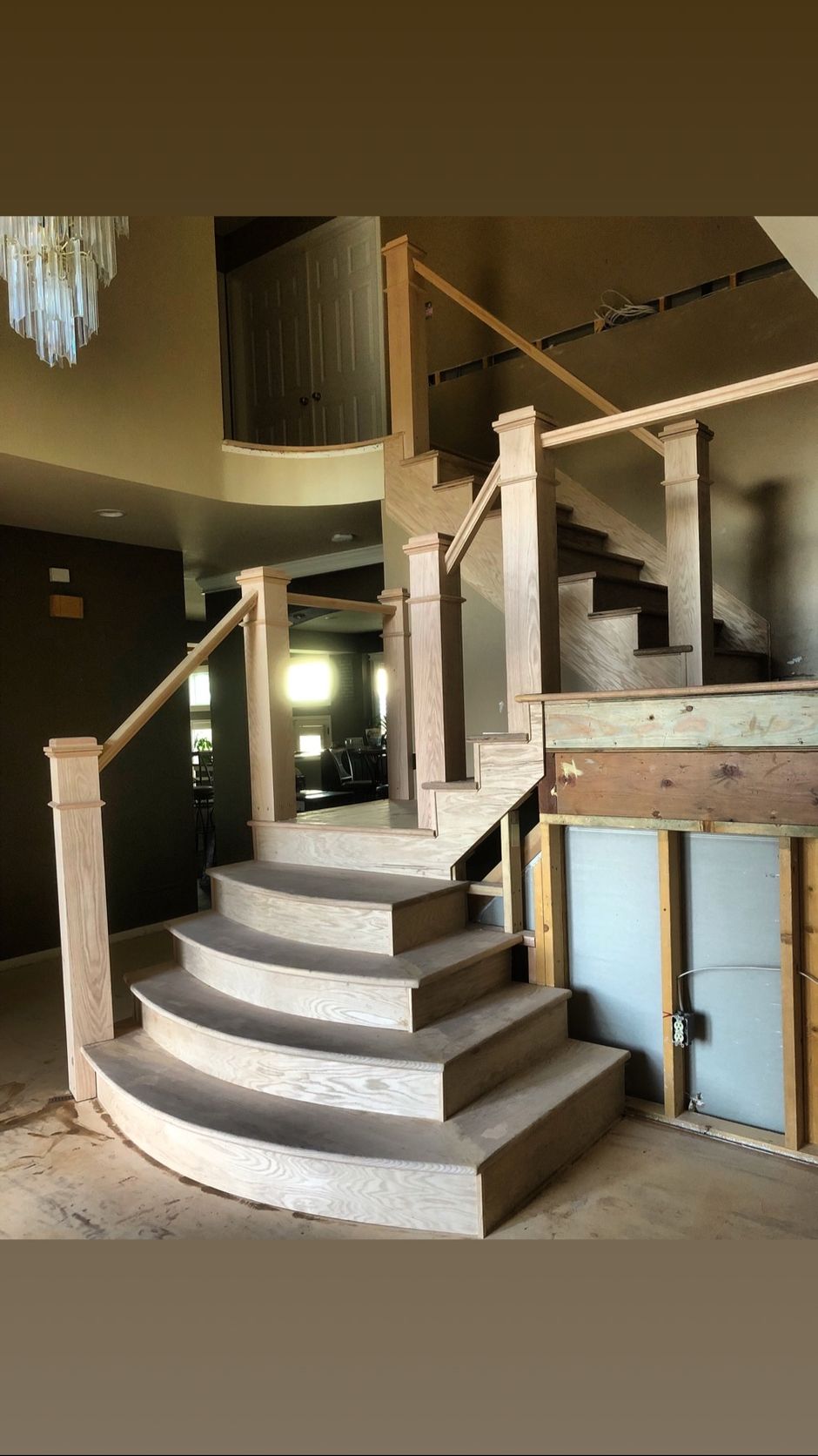 A picture of a staircase in a house under construction.