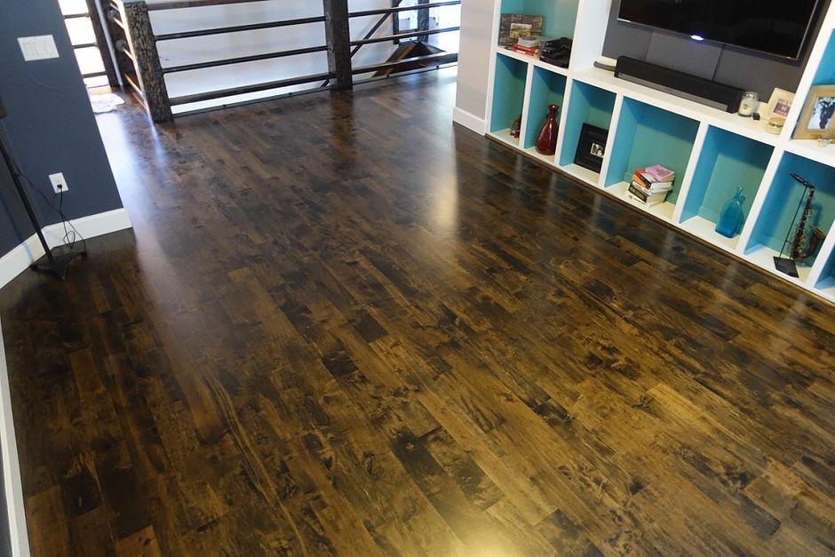 A living room with hardwood floors and blue shelves