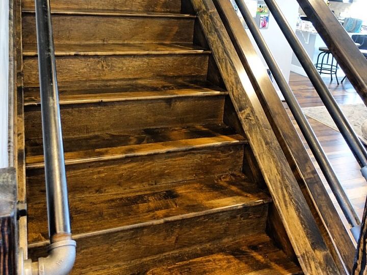 The stairs are made of wood and metal and have a metal railing. Custom stain and custom railings.