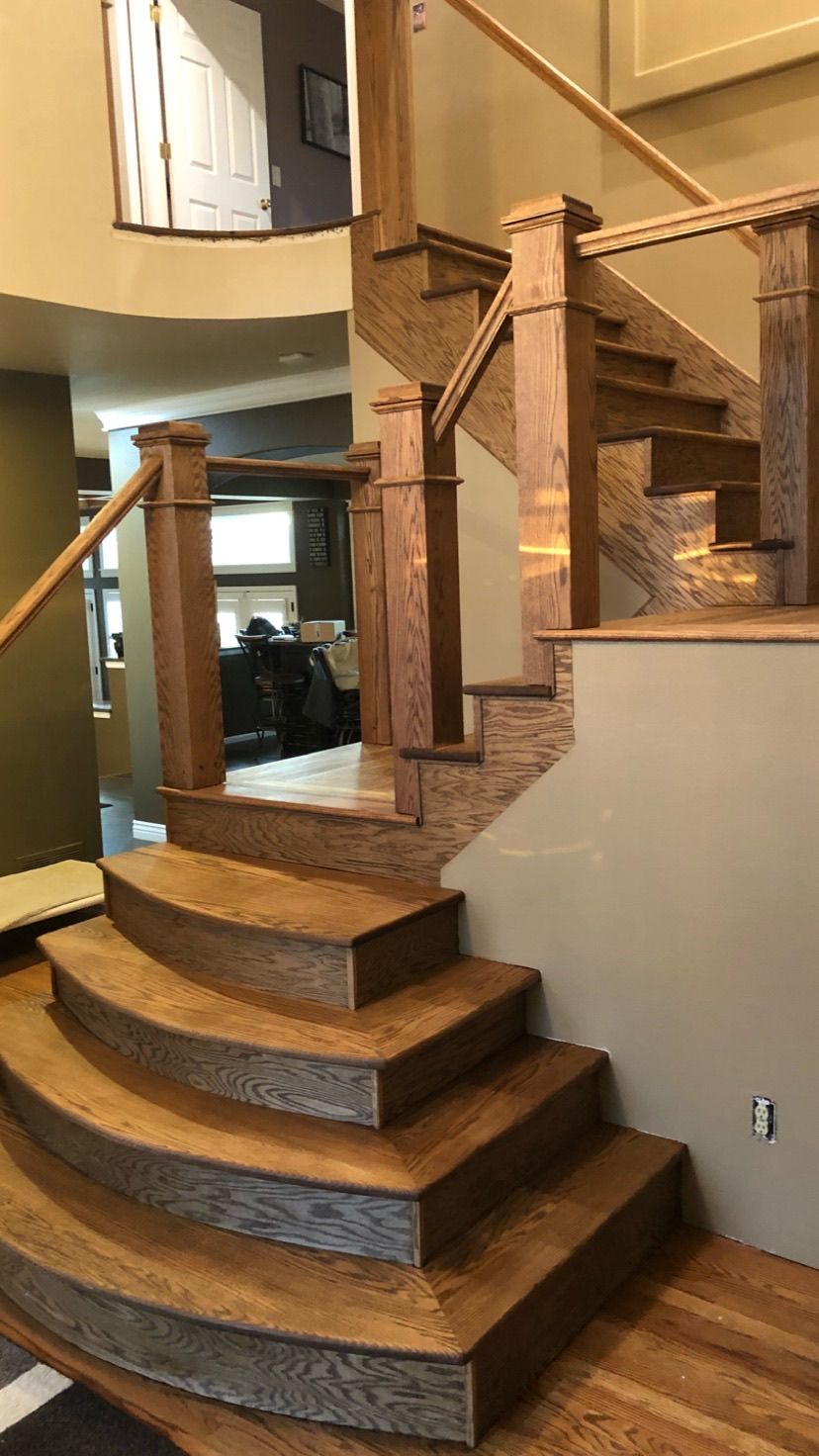 A wooden staircase leading up to a second floor in a house.