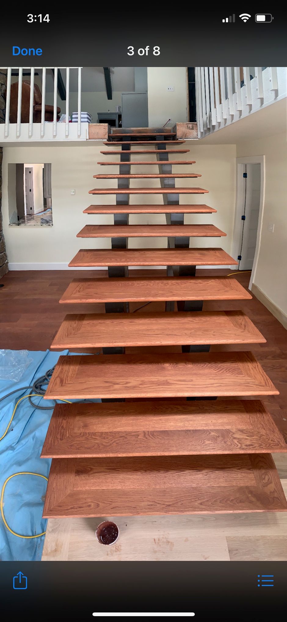 A picture of a wooden staircase being built in a house.