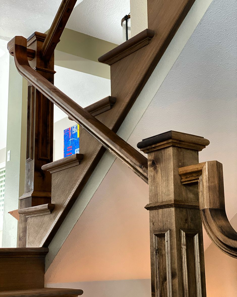 A close up of a wooden staircase with a railing