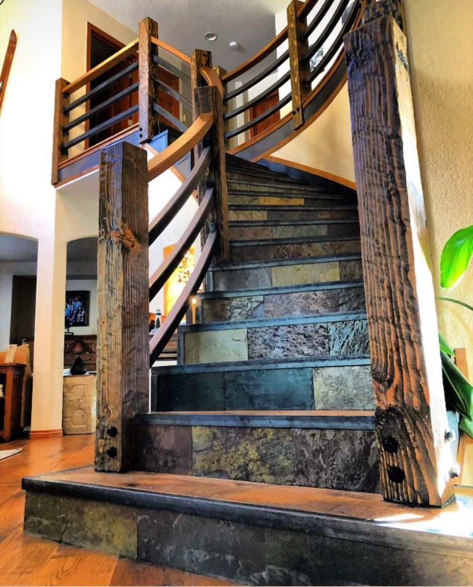 A spiral staircase with a wooden railing in a house