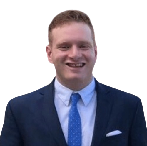 A man in a suit and tie is smiling for the camera.