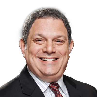 A man in a suit and tie is smiling for the camera