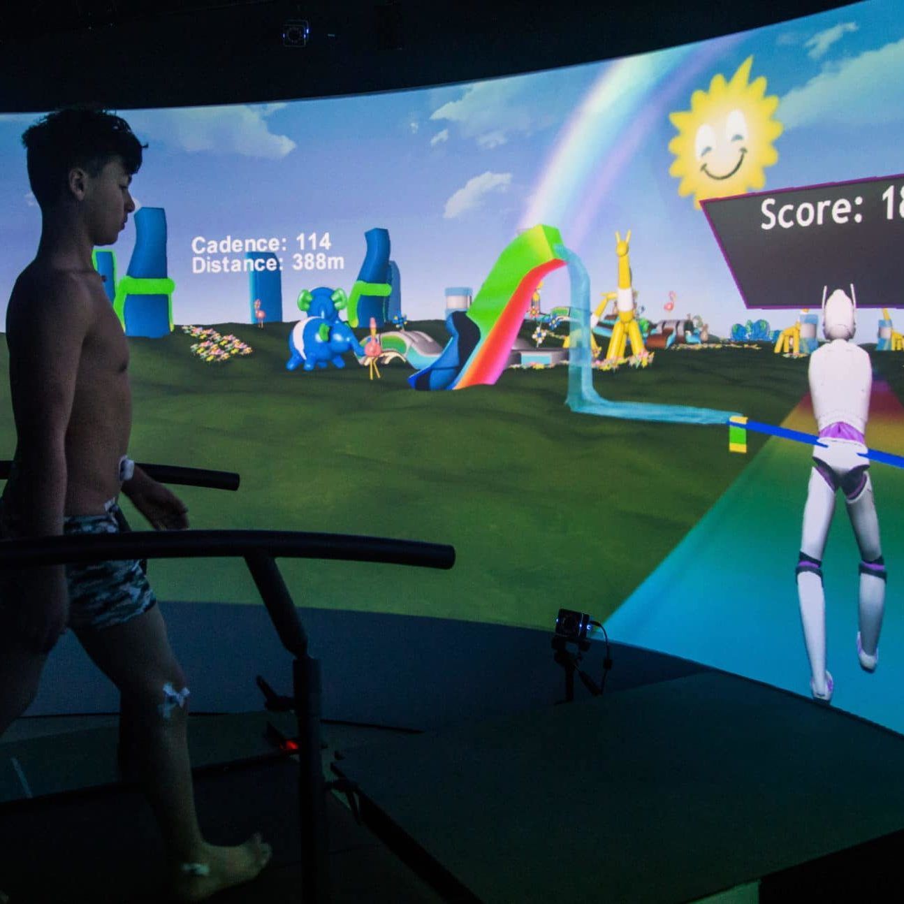 A man on a treadmill playing a video game with a score of 1