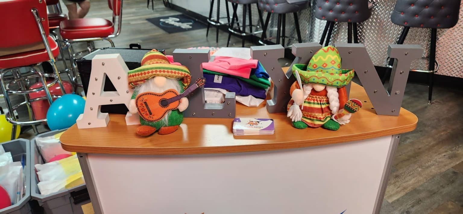 A wooden table with gnomes and letters on it.