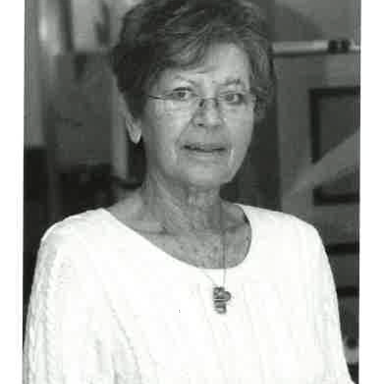 A black and white photo of an older woman wearing glasses and a necklace.