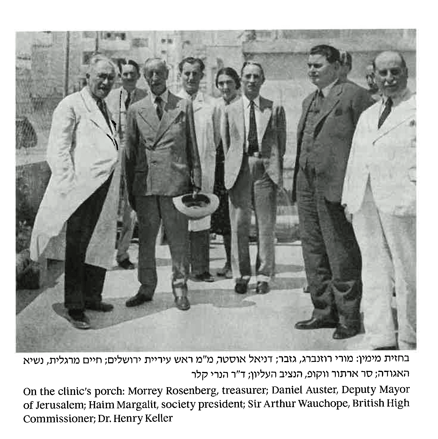 A black and white photo of a group of men standing next to each other