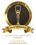 A golden circular World Luxury Hotel Awards 2024 badge featuring a trophy and text for regional hotel category winners.