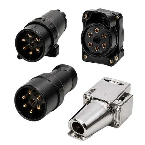 Assorted black and silver electrical connectors with round pin sockets on a white background