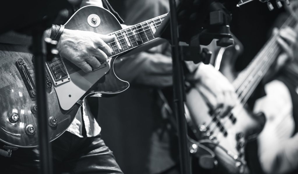 a man is playing a guitar in a black and white photo