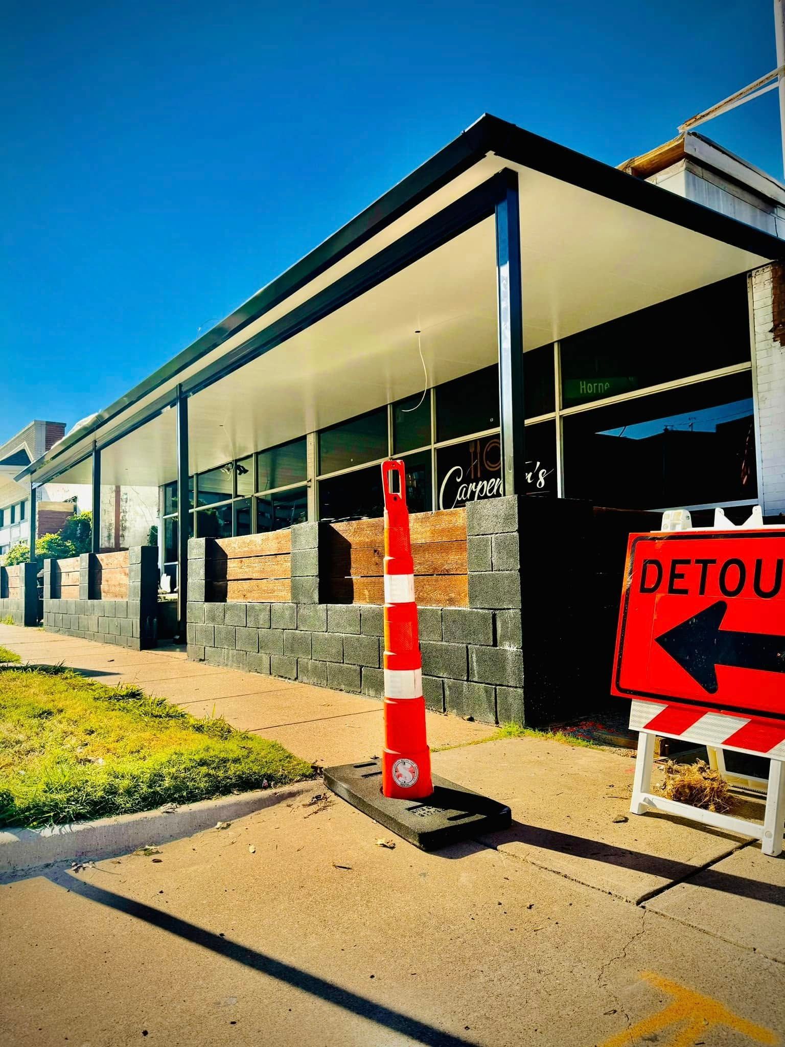 A building with a detour sign in front of it