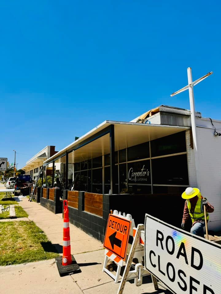 A road closed sign is in front of a building