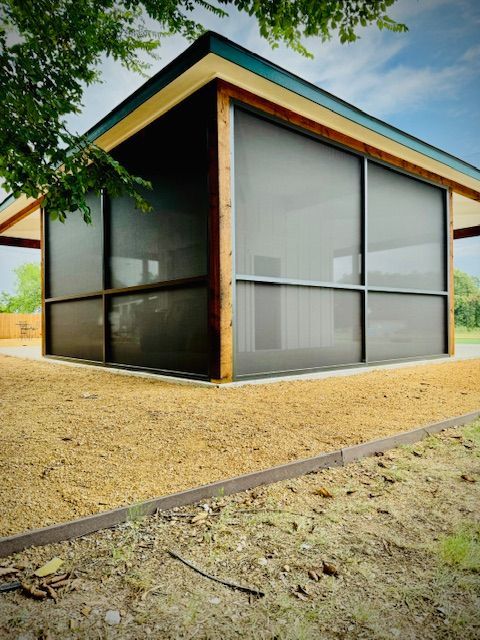 A screened in porch and a lot of windows